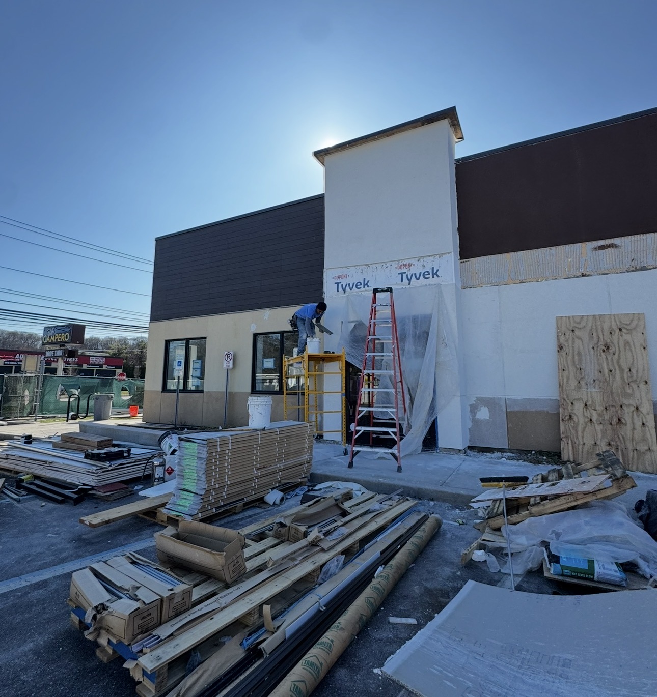 Pollo Campero construction phase showing exterior stucco and framing work in Huntington, NY