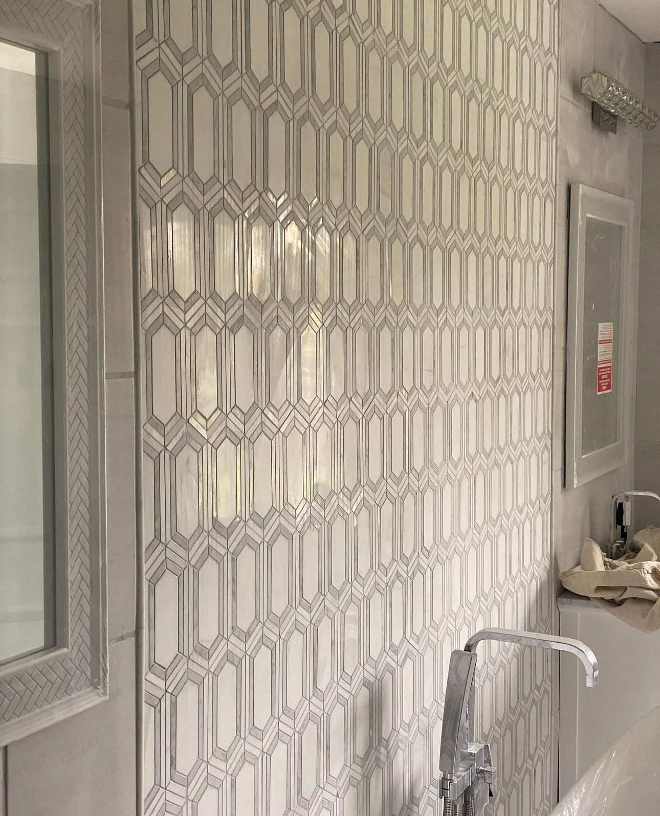 Decorative hexagonal tile detail on bathroom wall